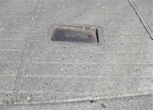 Utility covers not level with the sidewalk present dangers to anyone using the sidewalk